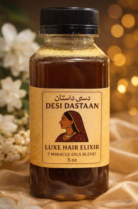 Bottle of Desi Dastaan Luxe Hair Elixir with a blurred floral and light background